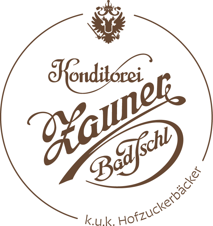 Zauner-Logo mit k.u.k. Hofzuckerbäcker Schriftzug, Bad Ischl und österreichischem Branding in warmem Braun auf schwarzem Hintergrund.